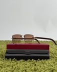 Occhiali da sole Cartier Signature C in metallo dorato con aste in legno