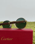 Cartier Eyewear Con montatura ovale e aste in legno
