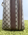 Valigia vintage Gucci realizzata in tela GG monogramma con dettagli in pelle marrone e strisce Web