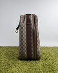Valigia vintage Gucci realizzata in tela GG monogramma con dettagli in pelle marrone e strisce Web