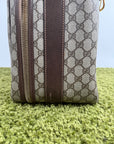 Valigia vintage Gucci realizzata in tela GG monogramma con dettagli in pelle marrone e strisce Web