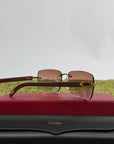 Occhiali da sole Cartier Signature C in metallo dorato con aste in legno