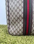 Valigia vintage Gucci realizzata in tela GG monogramma con dettagli in pelle marrone e strisce Web