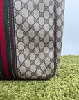 Valigia vintage Gucci realizzata in tela GG monogramma con dettagli in pelle marrone e strisce Web