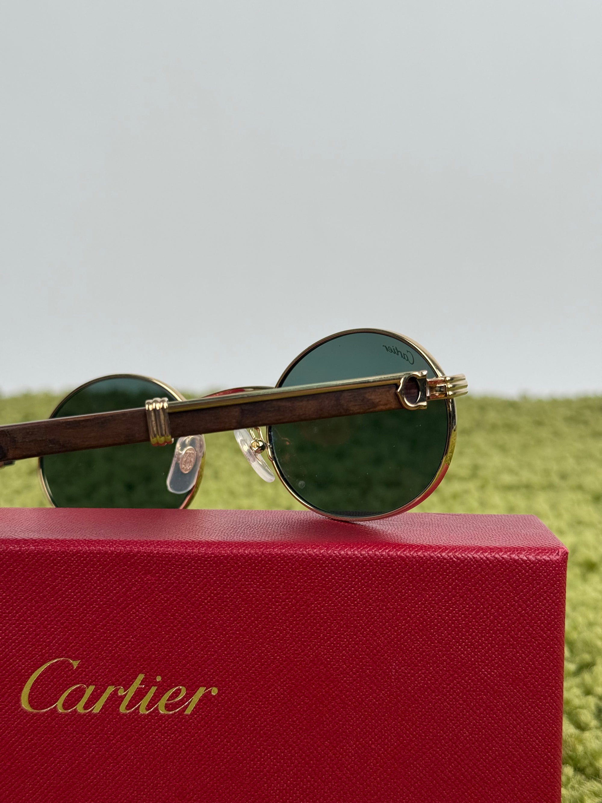 Cartier Eyewear Con montatura ovale e aste in legno