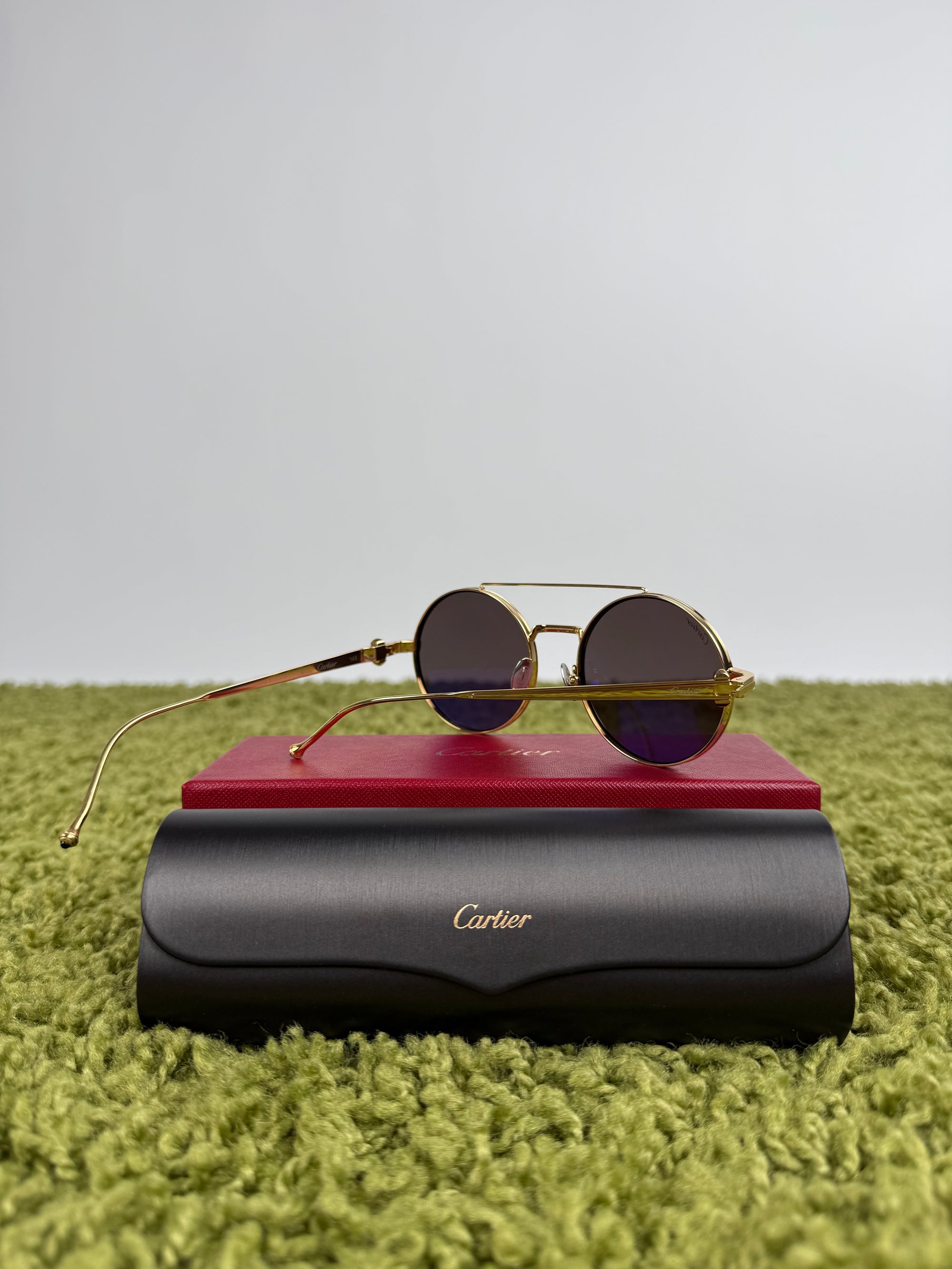 Occhiali da sole Cartier Tondi con montatura in metallo dorato e lenti scure
