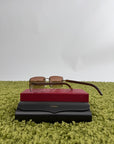 Occhiali da sole Cartier Signature C in metallo dorato con aste in legno