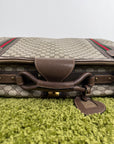 Valigia vintage Gucci realizzata in tela GG monogramma con dettagli in pelle marrone e strisce Web
