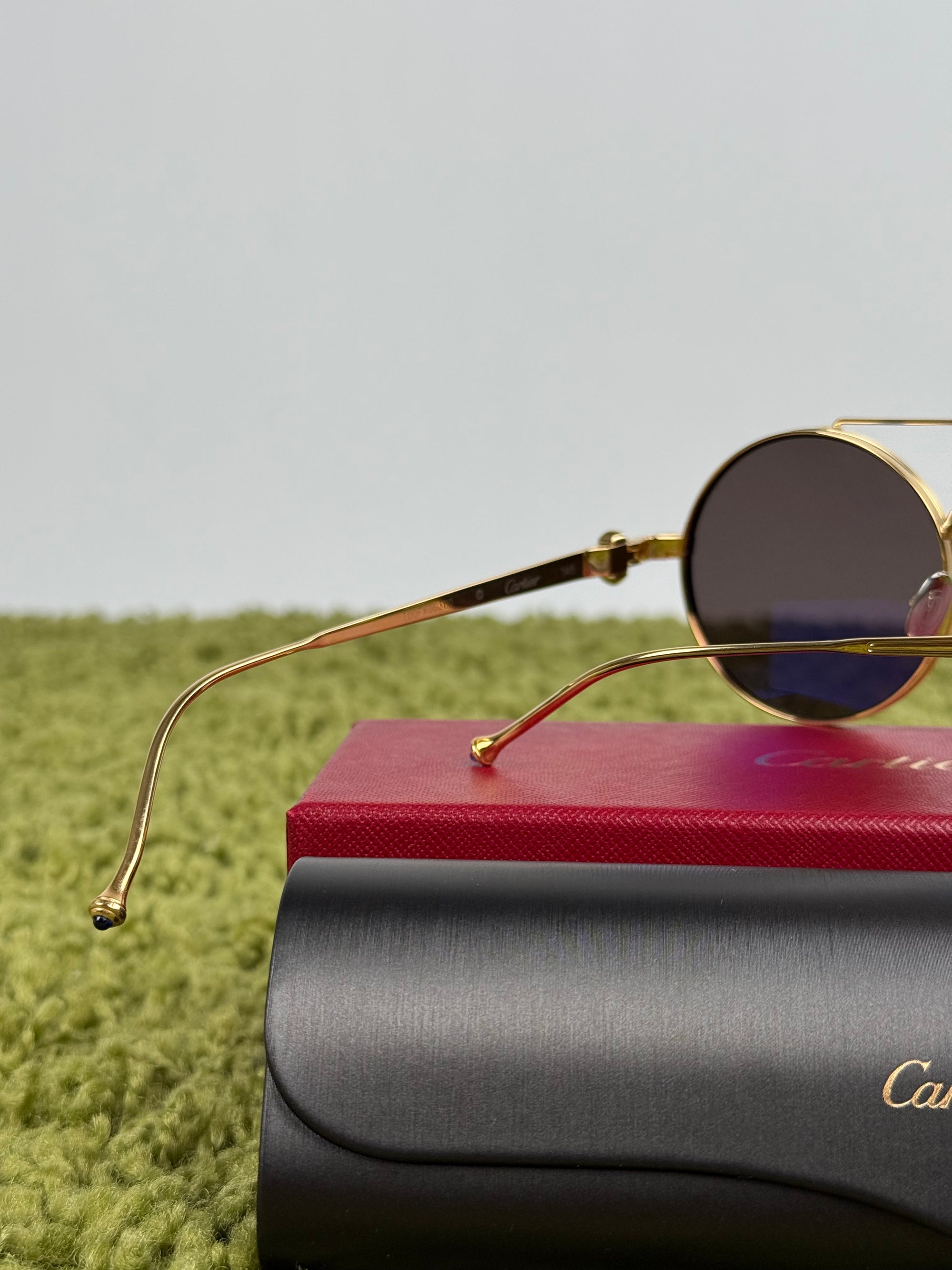 Occhiali da sole Cartier Tondi con montatura in metallo dorato e lenti scure