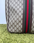 Valigia vintage Gucci realizzata in tela GG monogramma con dettagli in pelle marrone e strisce Web
