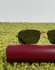 Occhiali Gucci Montatura oro con aste nere e lenti grigie