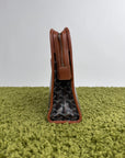 Pochette Goyard Jouvence in tela Goyardine nera con profili marroni