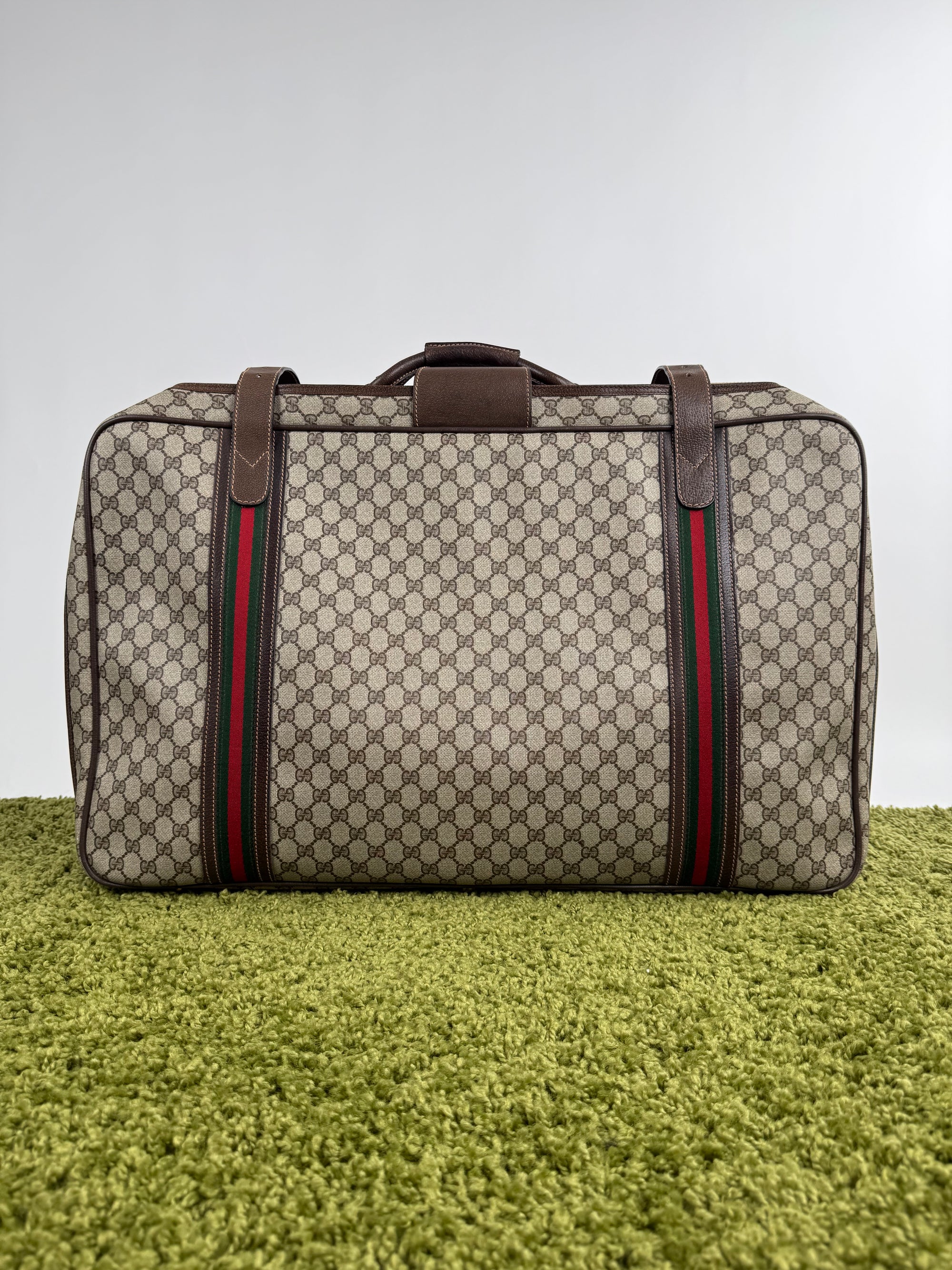 Valigia vintage Gucci realizzata in tela GG monogramma con dettagli in pelle marrone e strisce Web