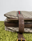 Valigia vintage Gucci realizzata in tela GG monogramma con dettagli in pelle marrone e strisce Web