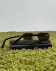 Occhiali da sole Cartier CT0622S con aste in acetato nero con un dettaglio dorato a forma di C