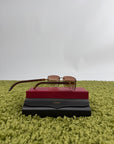Occhiali da sole Cartier Signature C in metallo dorato con aste in legno