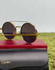 Occhiali da sole Cartier Tondi con montatura in metallo dorato e lenti scure