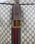 Valigia vintage Gucci realizzata in tela GG monogramma con dettagli in pelle marrone e strisce Web