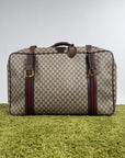 Valigia vintage Gucci realizzata in tela GG monogramma con dettagli in pelle marrone e strisce Web
